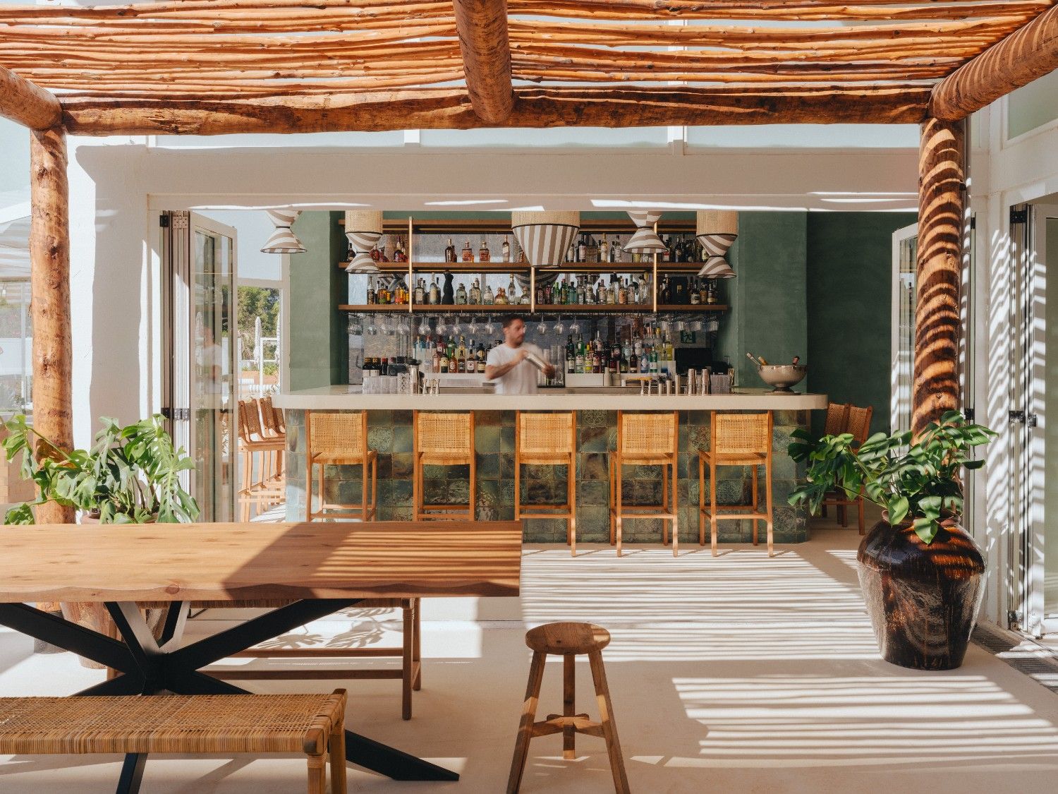 Image of Bungalow bar outside with a bar in the background and high chairs in front of it